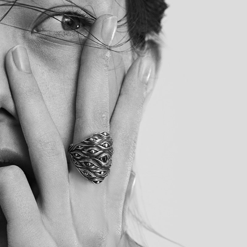 woman wearing silver ring with eye forest