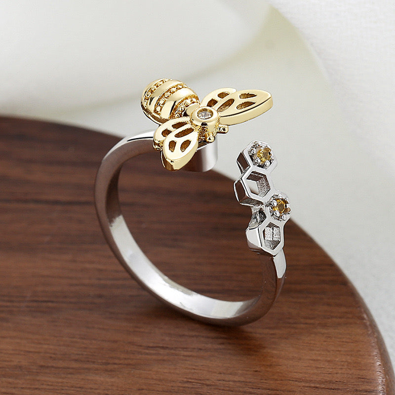 silver fidget ring with gold plated bee design