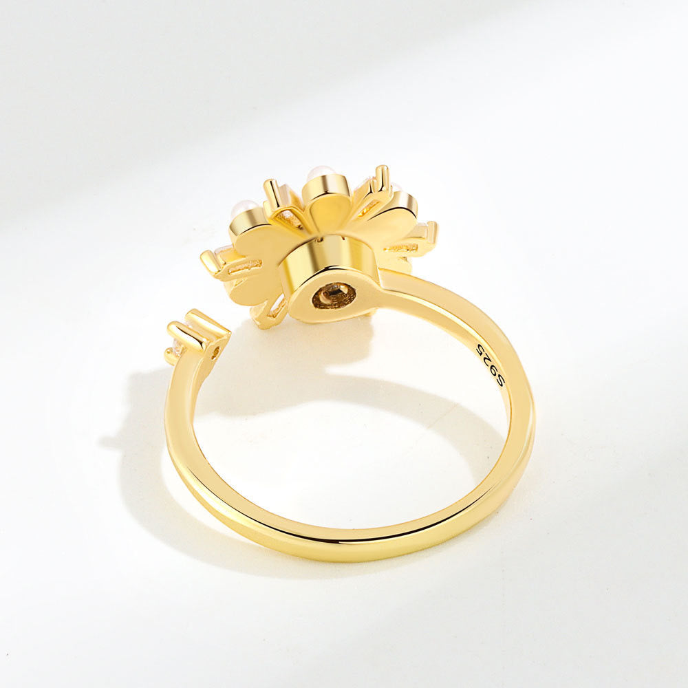 gold plated fidget ring with zirconia and pearl flower design