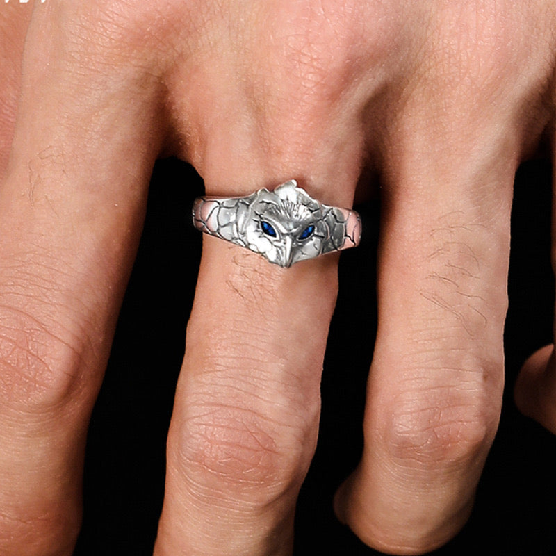 man wearing silver owl ring with blue zirconia details