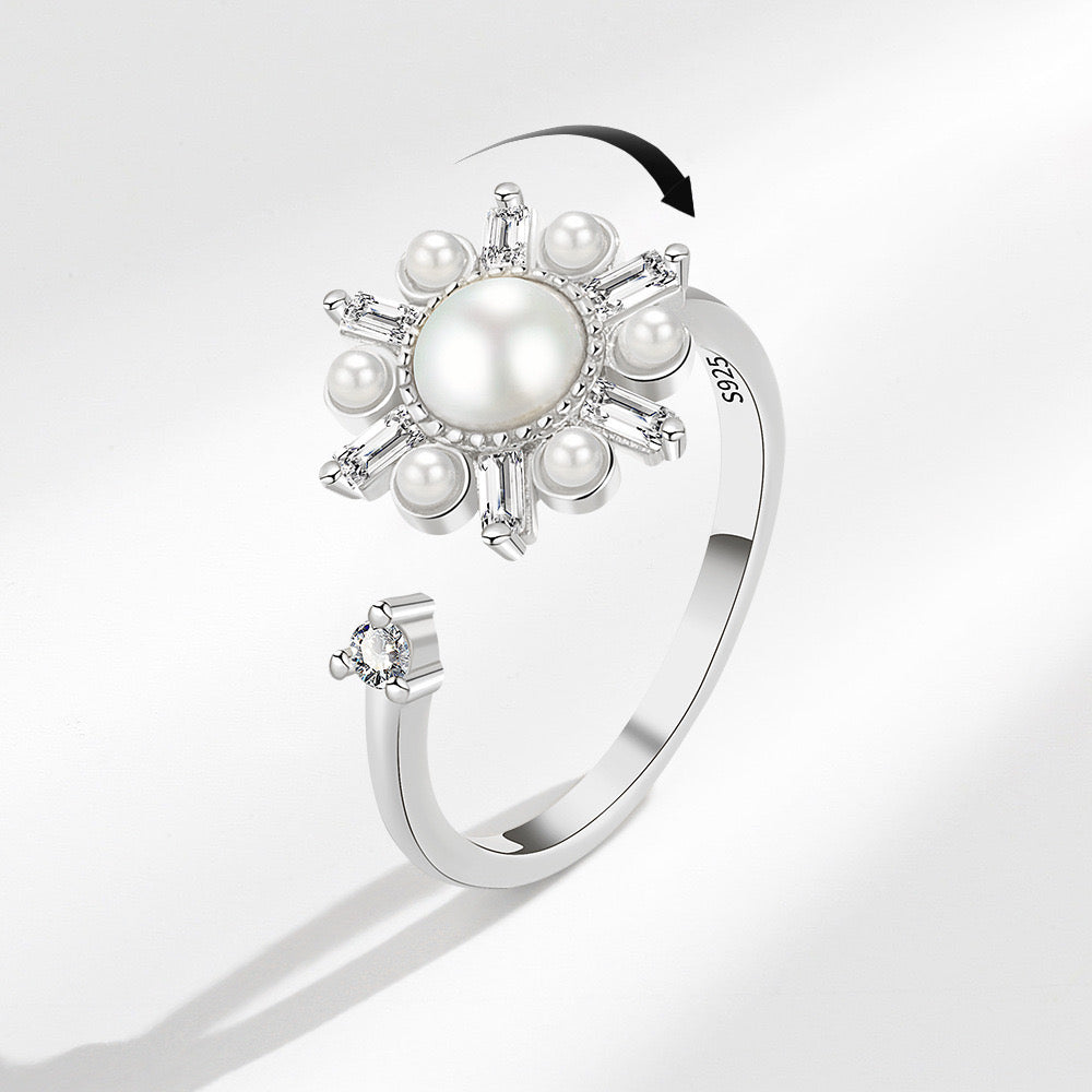 silver fidget ring with flower zirconia design