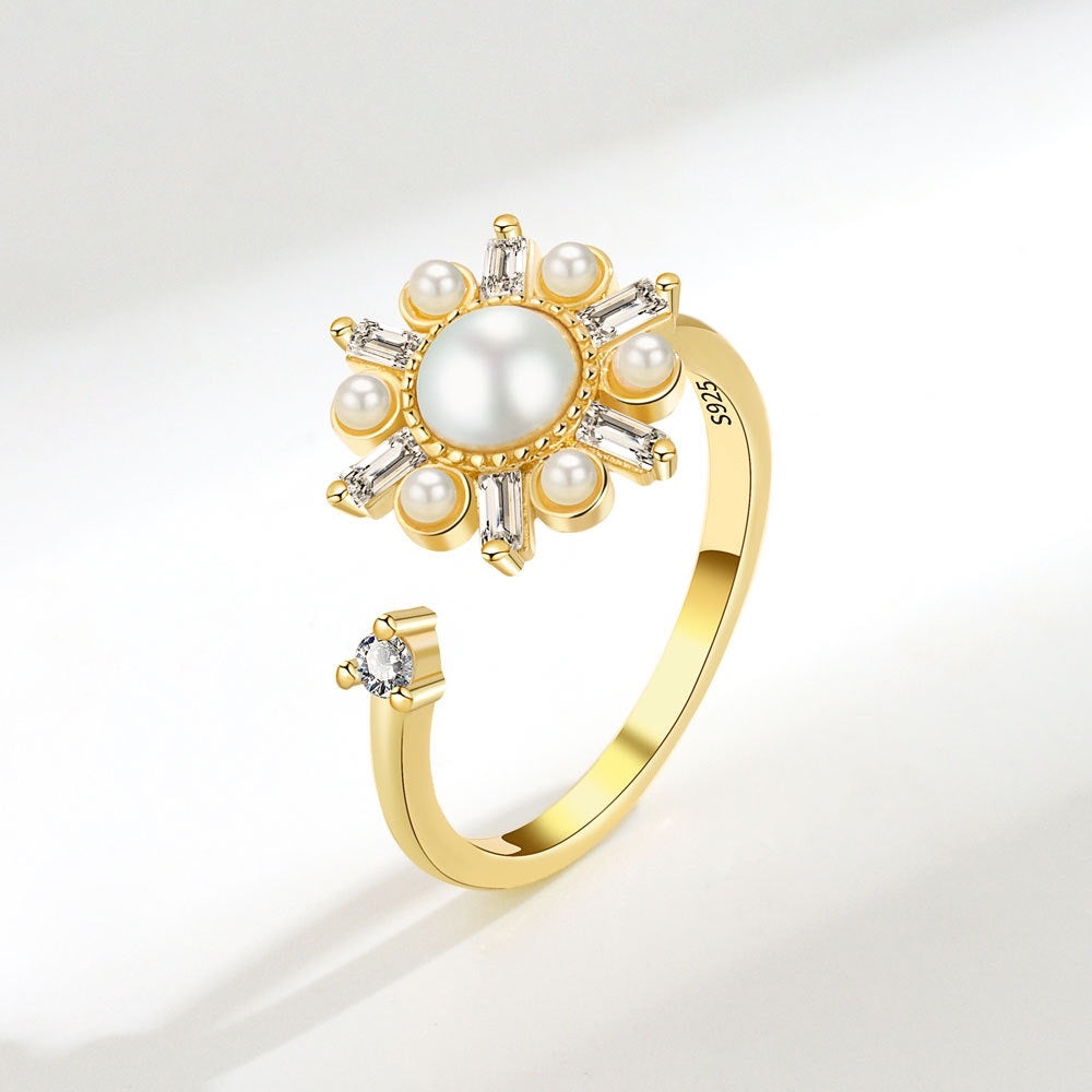 gold plated fidget ring with zirconia and pearl flower design