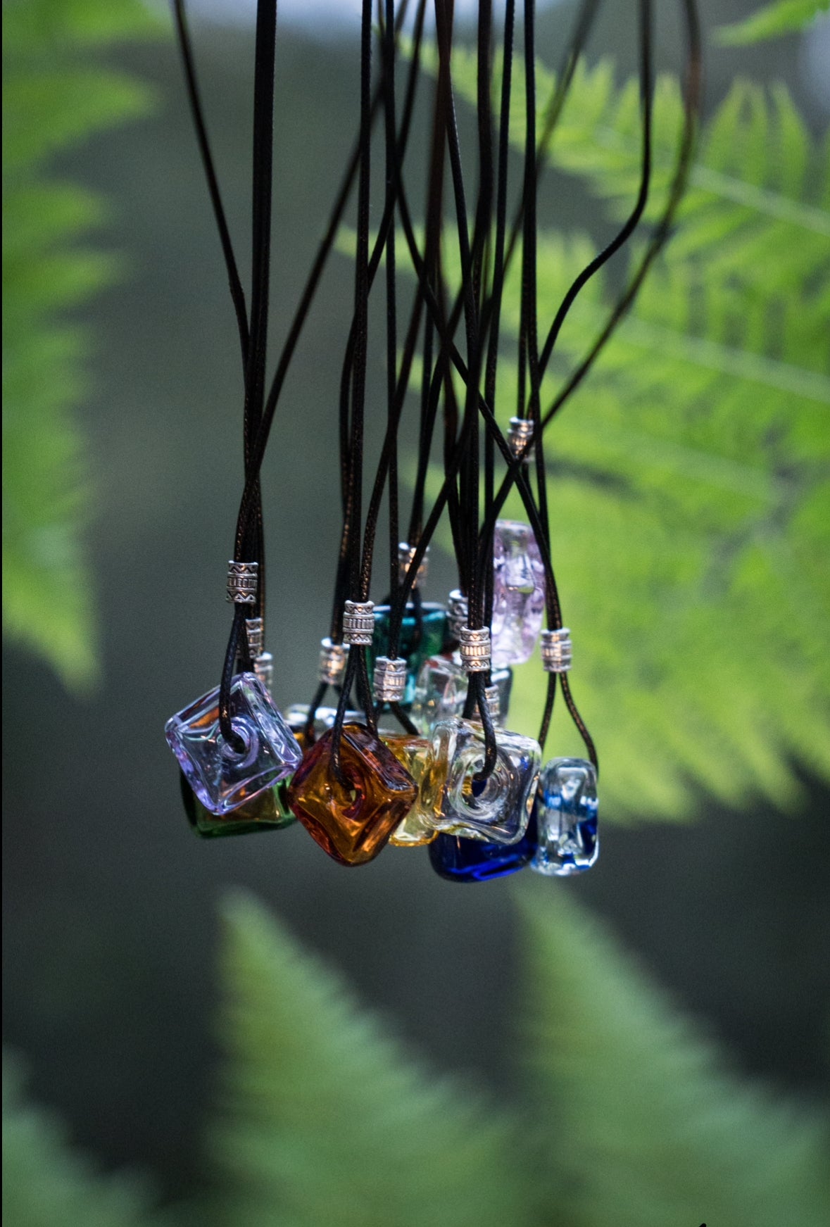 square oil bottle pendant with black string necklace