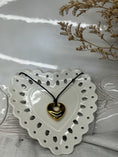 Load image into Gallery viewer, gold plated heart necklace with black strap necklace in heart shaped plate
