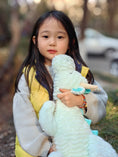 Load image into Gallery viewer, little girl hugging her dragon plushie
